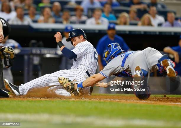 Jacoby Ellsbury of the New York Yankees scores on a sacrifice fly by Carlos Beltran in the third inning against the Toronto Blue Jays at Yankee...