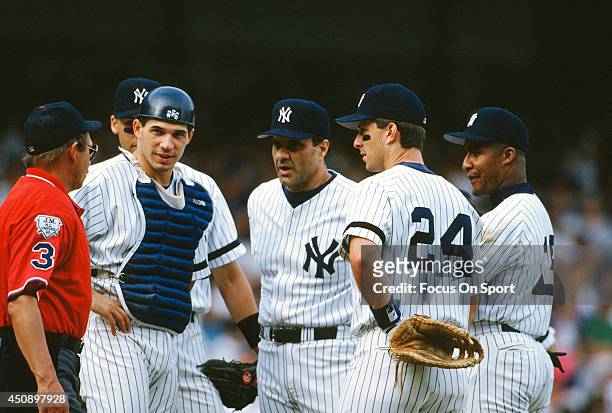 Manager Joe Torre of the New York Yankees stands on the mound with his players Derek Jeter, Joe Girardi, Tino Martinez and Mariano Duncan ##18 during...