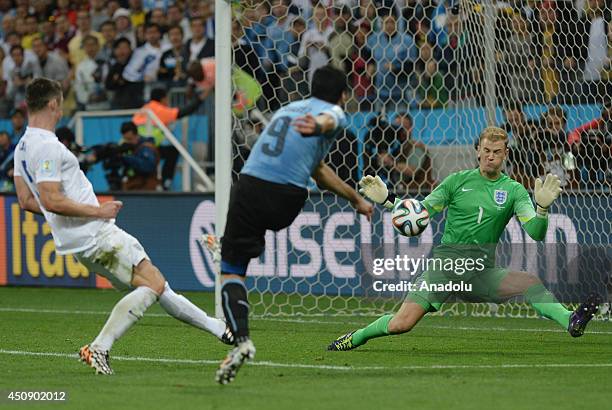 Gary Cahill of England challenges with Luis Suarez of Uruguay during the 2014 FIFA World Cup Group D match between Uruguay and England at Arena de...