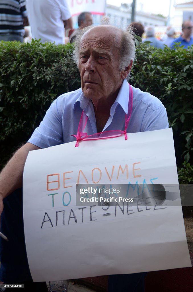 A demonstrator holds a placard with the message "we want our...