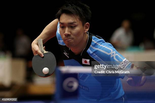 Taku Takakiwa of Japan returns a shot against Sun Chia-Hung of Taipei during their Men's Singles match on day one of 2014 ITTF World Tour Japan Open...