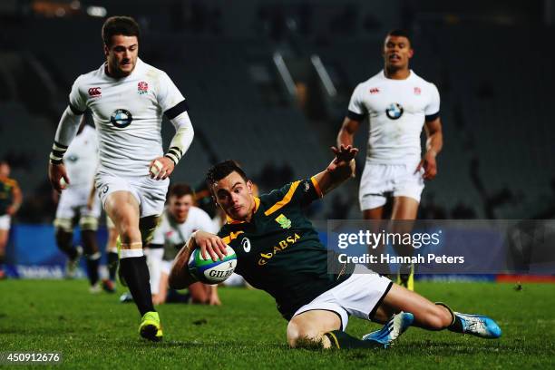 Jesse Kriel of South Africa dives over to score a try during the 2014 Junior World Championship Final match between South Africa and England at Eden...