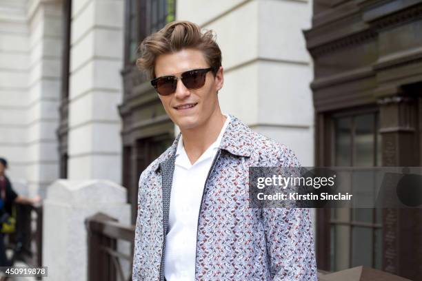 Model Oliver Cheshire wears a Dolce and Gabbana jacket, Reiss shirt and Eye-Respect sunglasses on day 3 of London Collections: Men on June 17, 2014...