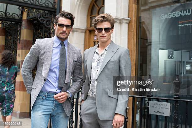 Model David Gandy with Model Oliver Cheshire who wears Eye-Respect sunglasses, Reiss suit, Zara shirt on day 2 of London Collections: Men on June 16,...