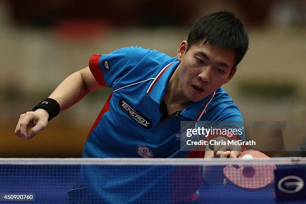 Huang Sheng-Sheng of Taipei returns a shot against Taku Takakiwa of Japan during their Men's Singles match on day one of 2014 ITTF World Tour Japan...