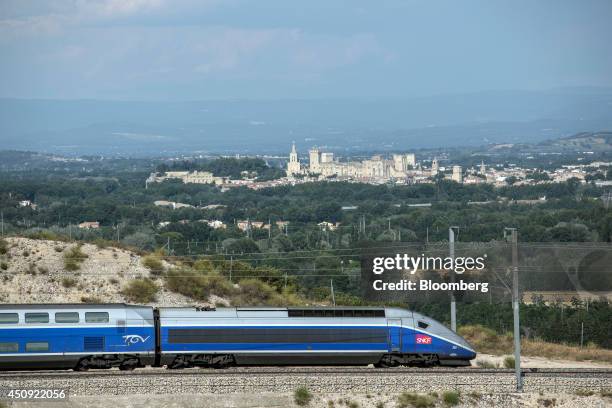 Duplex high-speed train, operated by Societe Nationale des Chemins de Fer and manufactured by Alstom SA, passes the city of Avignon as it arrives at...