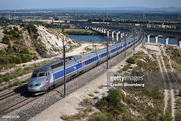 Duplex high-speed train, operated by Societe Nationale des Chemins de Fer and manufactured by Alstom SA, crosses the River Rhone outside Avignon as...