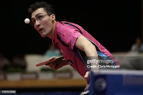 Adrien Mattenet of France serves against Marcos Madrid of Mexico during their Men's Singles match on day one of 2014 ITTF World Tour Japan Open at...