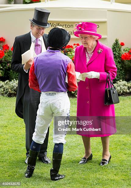 Queen Elizabeth II with Ryan Moore and John Warren attend Day 4 of Royal Ascot at Ascot Racecourse on June 20, 2014 in Ascot, England.