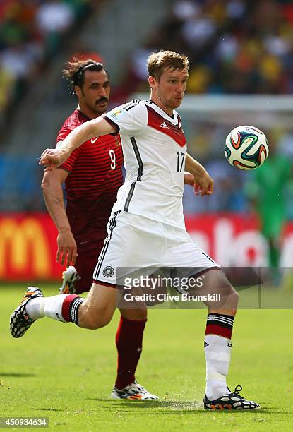 Per Mertesacker of Germany controls the ball against Hugo Almeida of Portugal during the 2014 FIFA World Cup Brazil Group G match between Germany and...