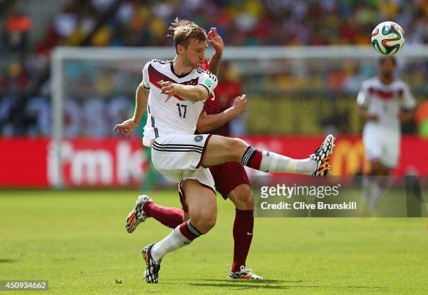 Per Mertesacker of Germany controls the ball against Hugo Almeida of Portugal during the 2014 FIFA World Cup Brazil Group G match between Germany and...