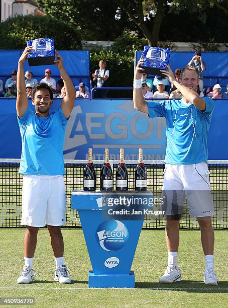 Treat Huey of Phillippines and Dominic Inglot of Great Britain pose with their winners trophies on day seven of the Aegon International at Devonshire...
