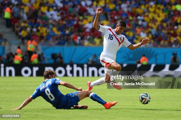 Claudio Marchisio of Italy tackles Cristian Gamboa of Costa Rica during the 2014 FIFA World Cup Brazil Group D match between Italy and Costa Rica at...