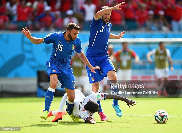 Joel Campbell of Costa Rica falls after a challenge by Giorgio Chiellini and Andrea Barzagli of Italy during the 2014 FIFA World Cup Brazil Group D...