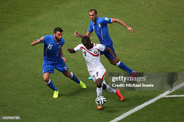 Joel Campbell of Costa Rica takes on Andrea Barzagli and Giorgio Chiellini of Italy during the 2014 FIFA World Cup Brazil Group D match between Italy...