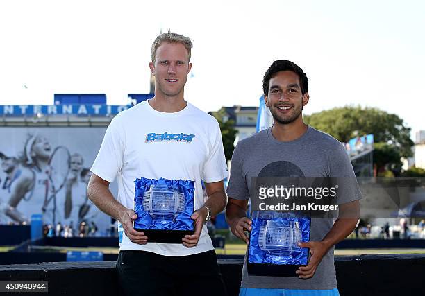 Treat Huey of Phillippines and Dominic Inglot of Great Britain pose with their winners trophies on day seven of the Aegon International at Devonshire...