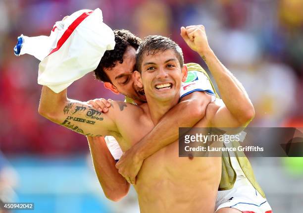 Cristian Gamboa of Costa Rica celebrates with Michael Barrantes after defeating Italy 1-0 during the 2014 FIFA World Cup Brazil Group D match between...