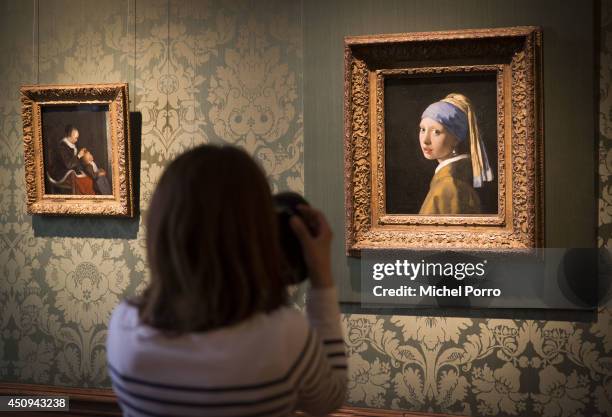 Journalist takes a photo of Johannes Vermeer's 'Girl with a Pearl Earring' in the Vermeer Room in the Mauritshuis Museum on June 20, 2014 in The...