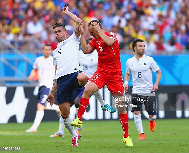 Steve von Bergen of Switzerland collides with Olivier Giroud of France during the 2014 FIFA World Cup Brazil Group E match between Switzerland and...