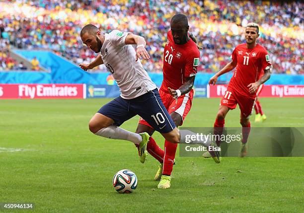 Karim Benzema of France is fouled by Johan Djourou of Switzerland and awarded a penalty kick during the 2014 FIFA World Cup Brazil Group E match...