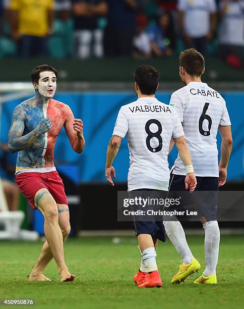 Pitch invader runs woard Mathieu Valbuena and Yohan Cabaye of France during the 2014 FIFA World Cup Brazil Group E match between Switzerland and...