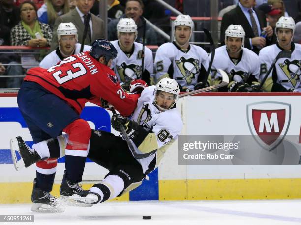 Tyson Strachan of the Washington Capitals checks Sidney Crosby of the Pittsburgh Penguins during the second period at Verizon Center on November 20,...