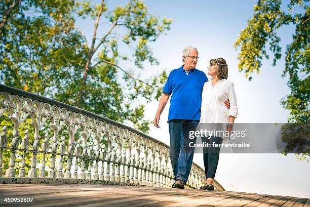 senior couple in central park - couple central park stockfoto's en -beelden