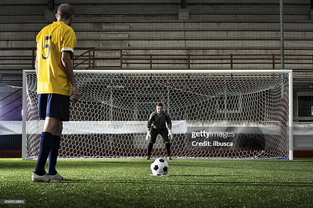 Football match in stadium: Penalty kick