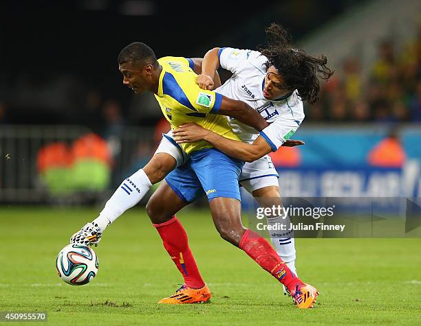 Oswaldo Minda of Ecuador battles for the ball with Roger Espinoza of Honduras during the 2014 FIFA World Cup Brazil Group E match between Honduras...