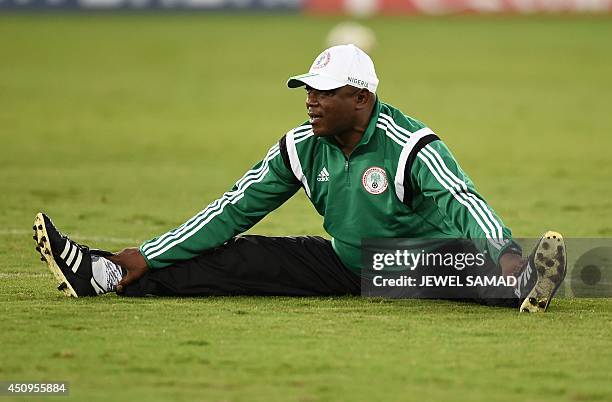 Nigeria's coach Stephen Keshi stretches during a training session at the Pantanal Arena in Cuiaba on June 20 on the eve of their 2014 FIFA World Cup...