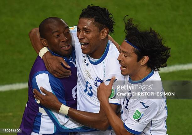 Honduras' forward Carlo Costly celebrates with teammates after scoring during a Group E football match between Honduras and Ecuador at the Baixada...