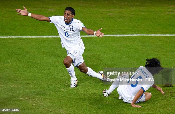 Carlo Costly of Honduras celebrates scoring his team's first goal with his teammate Roger Espinoza during the 2014 FIFA World Cup Brazil Group E...