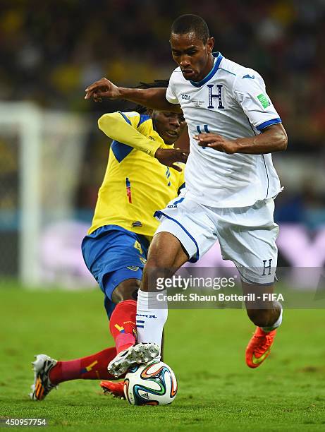 Jerry Bengtson of Honduras and Juan Carlos Paredes of Ecuador compete for the ball during the 2014 FIFA World Cup Brazil Group E match between...