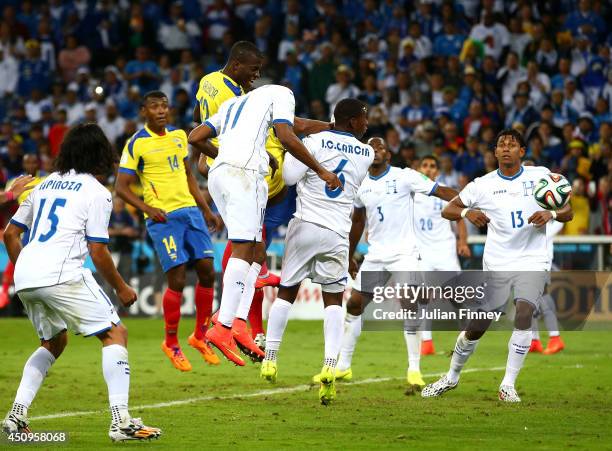 Enner Valencia of Ecuador scores his team's second goal on a header against Jerry Bengtson of Honduras during the 2014 FIFA World Cup Brazil Group E...