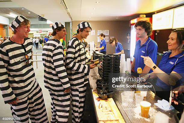 Barmy Army members dressed as convicts wait in line to purchase beer during day one of the First Ashes Test match between Australia and England at...