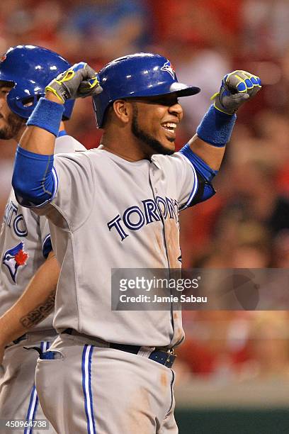Edwin Encarnacion of the Toronto Blue Jays celebrates in the ninth inning after hitting his second three-run home run against the Cincinnati Reds at...