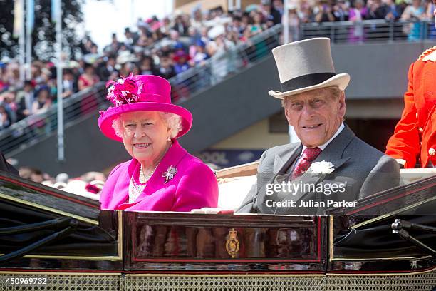 Queen Elizabeth II and Prince Philip Duke of Edinburgh attend Day 4 of Royal Ascot at Ascot Racecourse on June 20, 2014 in Ascot, England.