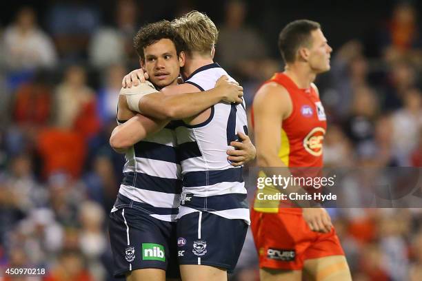 Steven Motlop of the Cats celebrates a goal with team mate Josh Caddy during the round 14 AFL match between the Gold Coast Suns and the Geelong Cats...