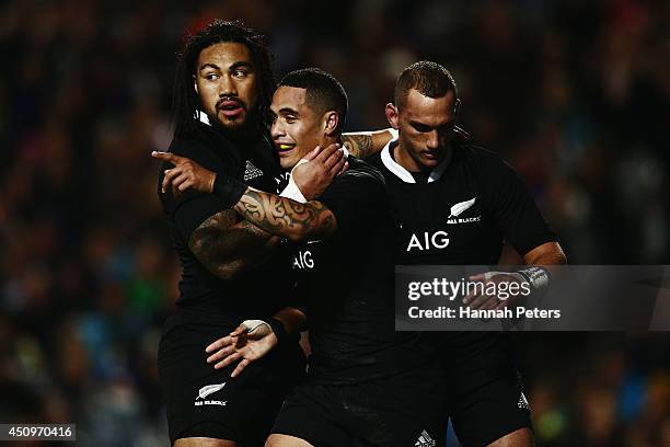 Aaron Smith of the All Blacks celebrates with Ma'a Nonu and Aaron Cruden after scoring his second try during the International Test match between the...