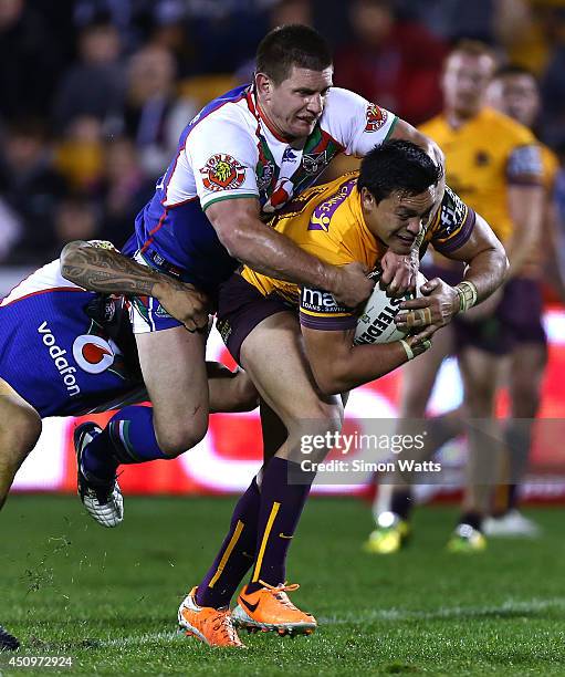 Alex Glenn of the Broncos is tackled by Jacob Lillyman of the Warriors during the round 15 NRL match between the New Zealand Warriors and the...