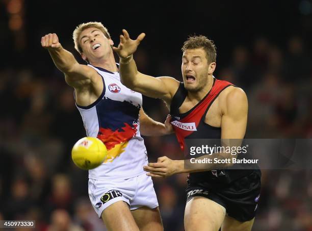 Tom Bellchambers of the Bombers and Daniel Talia of the Crows compete for the ball during the round 14 AFL match between the Essendon Bombers and the...