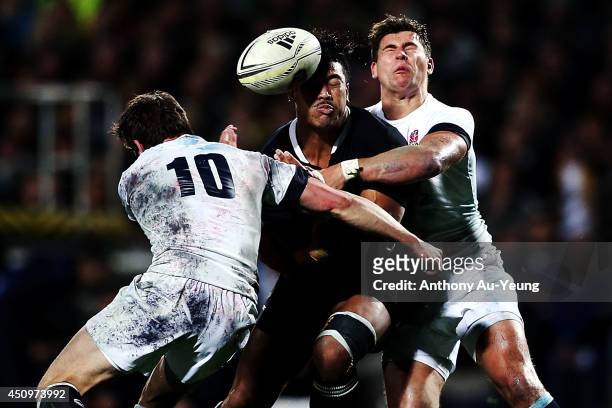 Julian Savea of New Zealand loses the ball in the tackle from Ben Youngs and Freddie Burns of England during the International Test match between the...