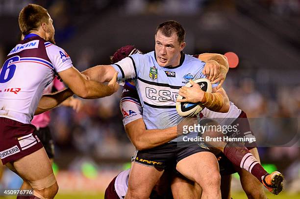 Paul Gallen of the Sharks is tackled during the round 15 NRL match between the Cronulla-Sutherland Sharks and the Manly-Warringah Sea Eagles at...