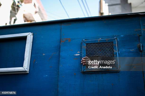 Prisoners leave the court in a police van after Egyptian court's death sentences about 183 Islamists in Minya, Cairo on June 21, 2014. Egyptian court...
