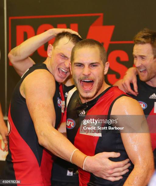 Brendon Goddard and David Zaharakis of the Bombers celebrate in the changing rooms as they sing the team song after winning during the round 14 AFL...