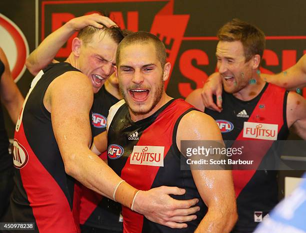 Brendon Goddard and David Zaharakis of the Bombers celebrate in the changing rooms as they sing the team song after winning during the round 14 AFL...