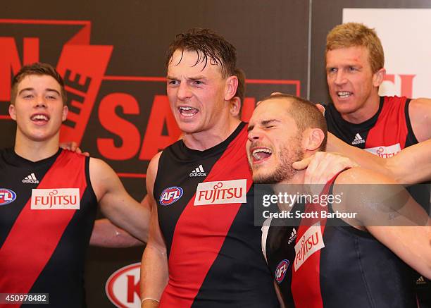 Brendon Goddard and David Zaharakis of the Bombers celebrate in the changing rooms as they sing the team song after winning during the round 14 AFL...