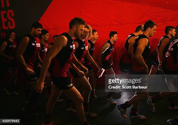 The Bombers run onto the field during the round 14 AFL match between the Essendon Bombers and the Adelaide Crows at Etihad Stadium on June 21, 2014...