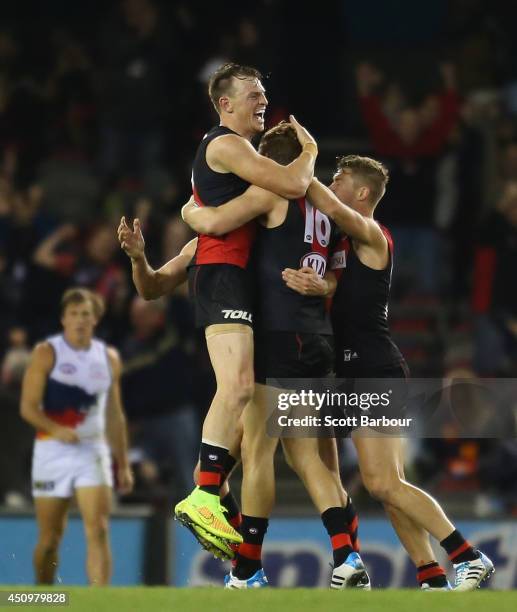 Brendon Goddard congratulates Michael Hurley of the Bombers after he kicked a goal during the round 14 AFL match between the Essendon Bombers and the...