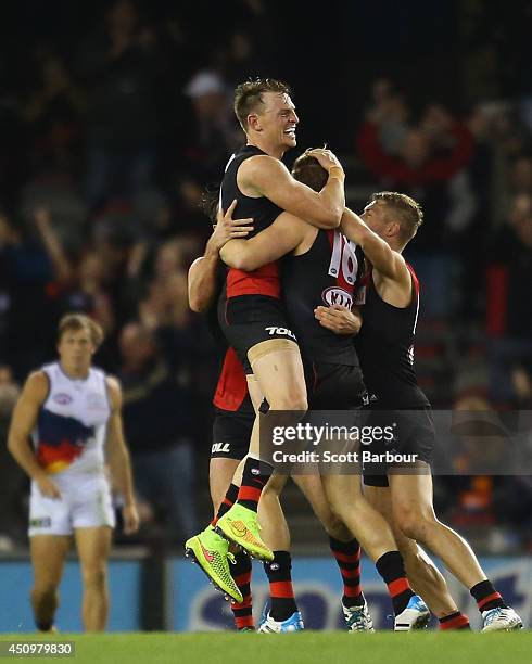 Brendon Goddard congratulates Michael Hurley of the Bombers after he kicked a goal during the round 14 AFL match between the Essendon Bombers and the...